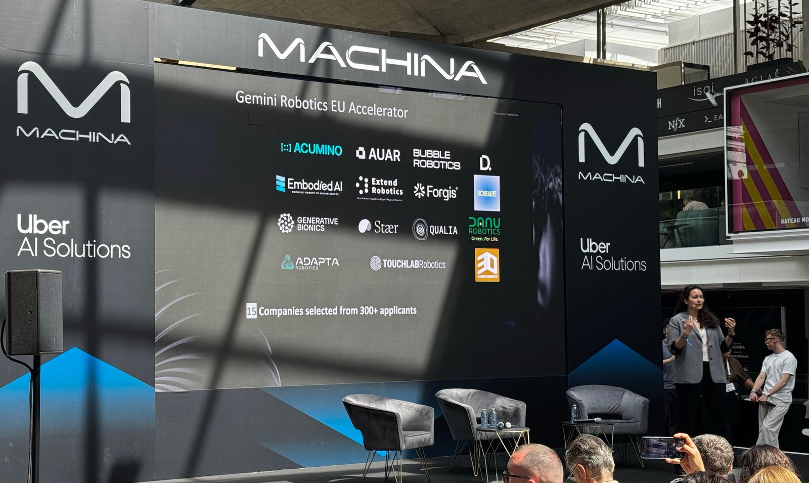 MACHINA Summit stage showing the Gemini Robotics EU Accelerator cohort — Acumino alongside 14 other startups selected from 300+ applicants