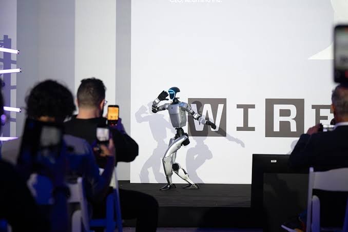 Humanoid robot posed on stage at the WIRED Greece Autonomy event, WIRED wordmark backdrop